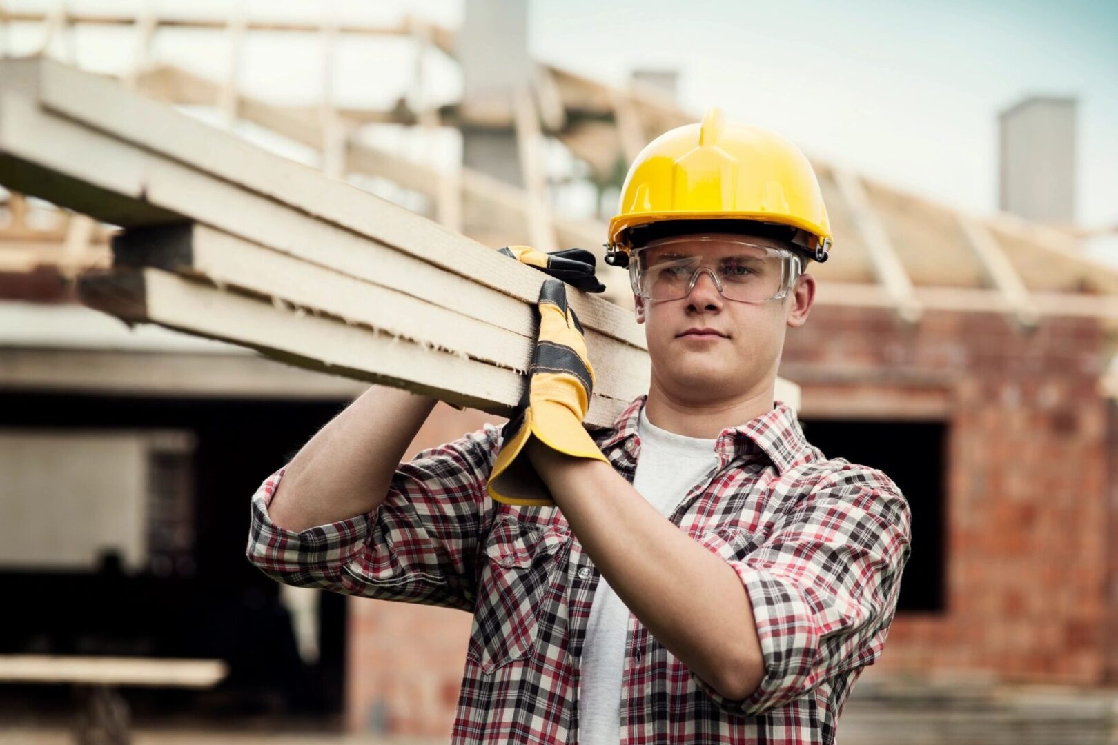 man lifting wood